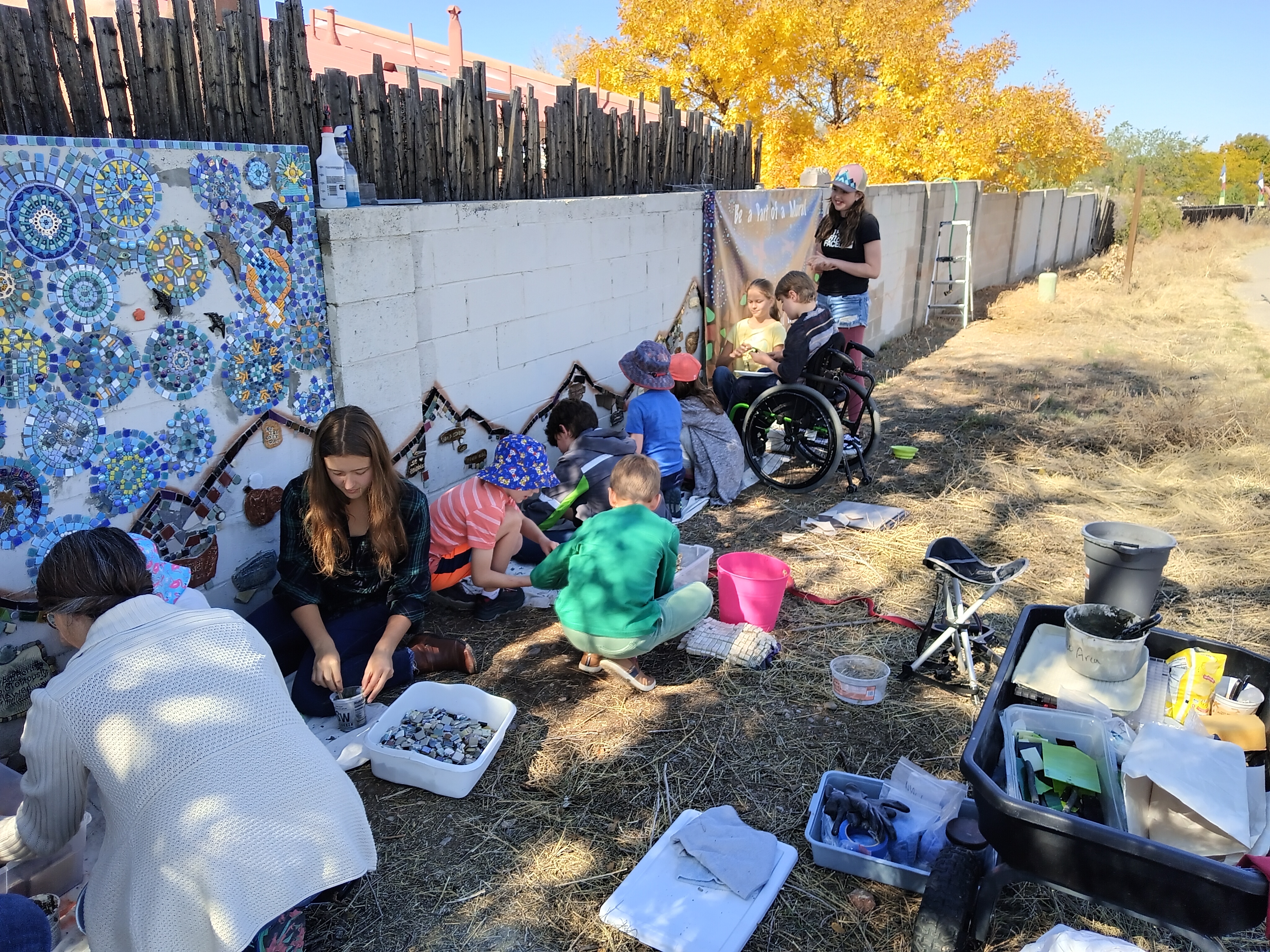 home school kids and parents working on the wall, October 2022