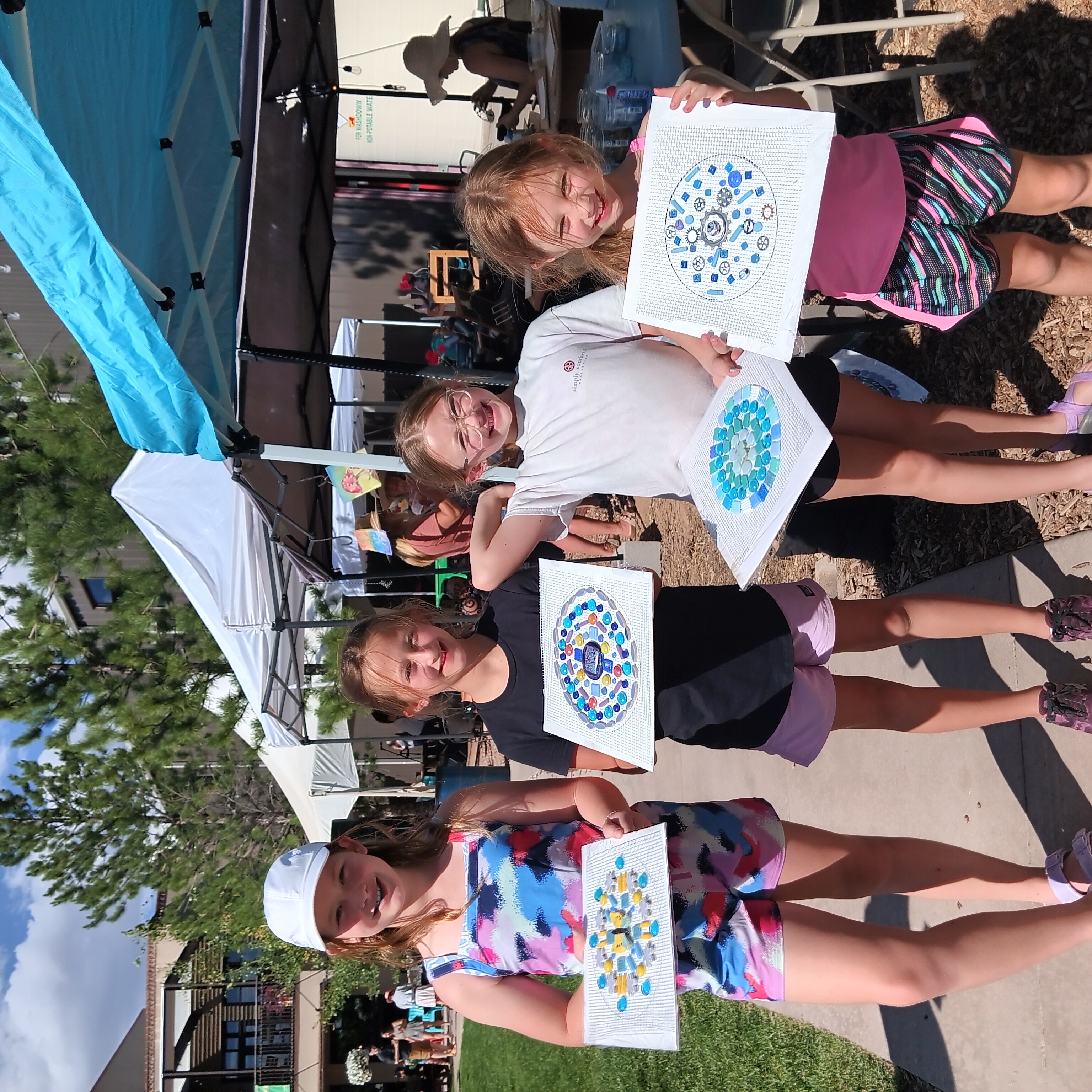 4 children with the mandalas they just made for the mural